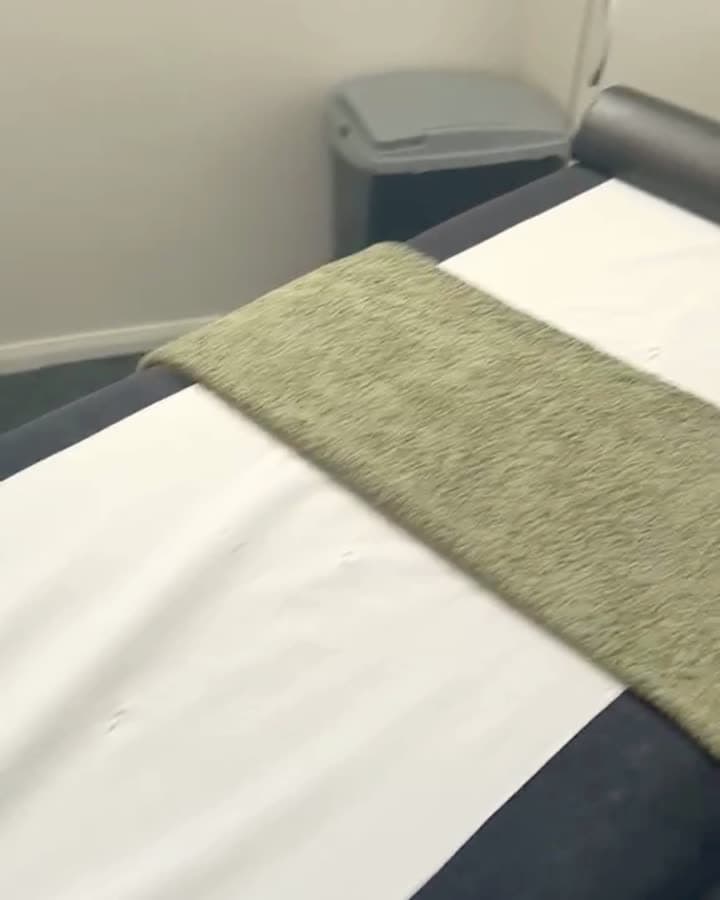 Reel frame: the Lift Ready treatment couch with a green towel across it.