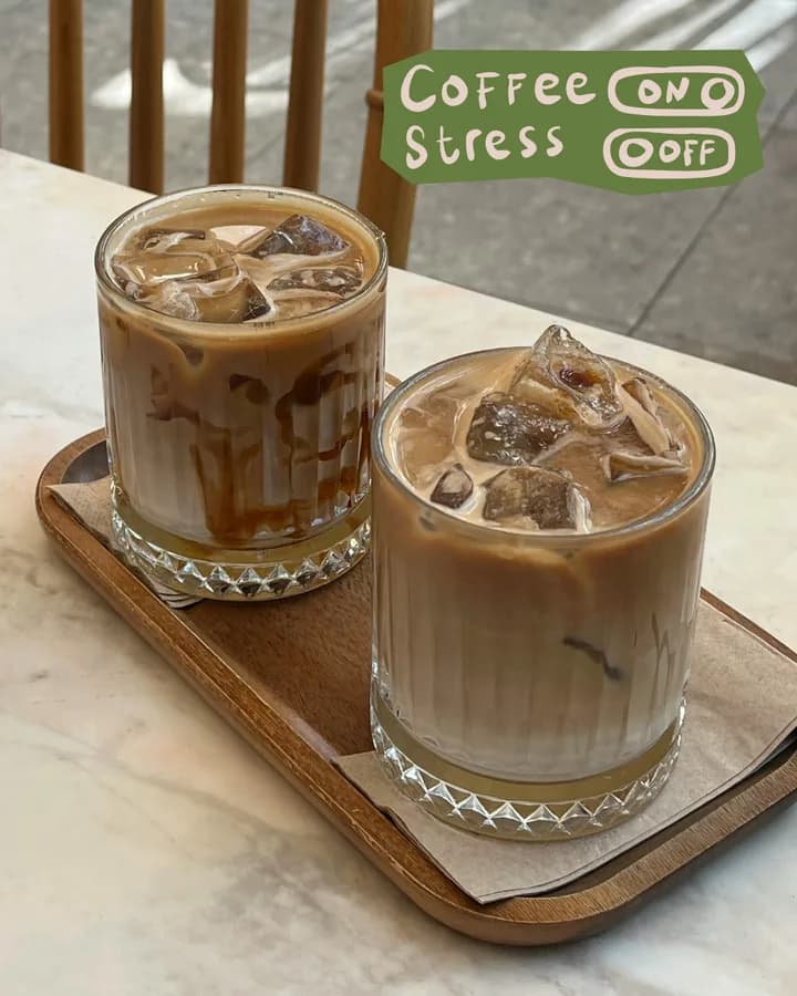 Concept post: Coffee on, stress off, two iced coffees on a wooden tray.